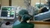 FILE - A hospital staffer monitors the vital signs of a suspected bird flu patient. Experts say the 3-D thread is a vast improvement over other biological diagnostic devices.