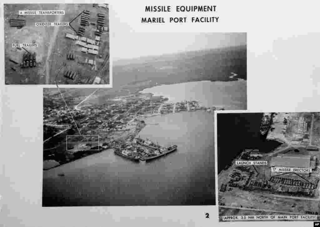 This file photo shows pictures released by the U.S.Defense Department of Mariel naval port in Cuba on November 4, 1962. The department identified the ships at dockside as Soviet freighters. Photo at upper left is a blowup of missile equipment in outline