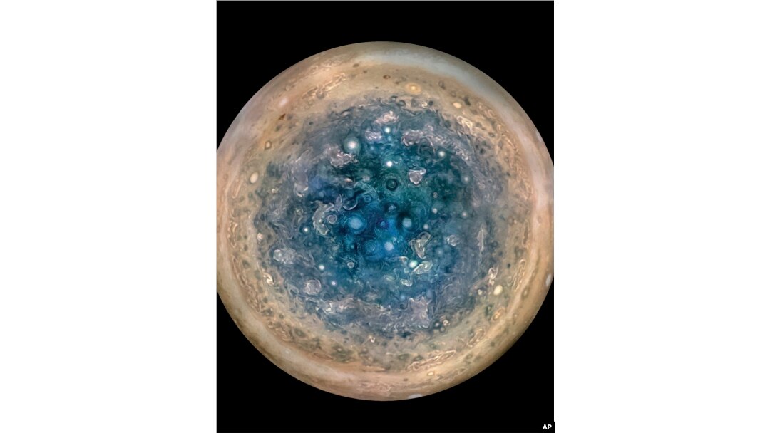 This image made available by NASA on May 25, 2017, and made from data captured by the Juno spacecraft shows Jupiter's south pole. The oval features are cyclones, up to 600 miles (1,000 kilometers) in diameter.