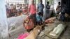 An elderly woman grieves next dead bodies at Mymensingh Medical College Hospital in the town of Mymensingh, Bangladesh, July 10, 2015. 