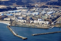 An aerial view shows the storage tanks for treated water at the tsunami-crippled Fukushima Daiichi nuclear power plant in Okuma town, Fukushima prefecture, on February 13, 2021.