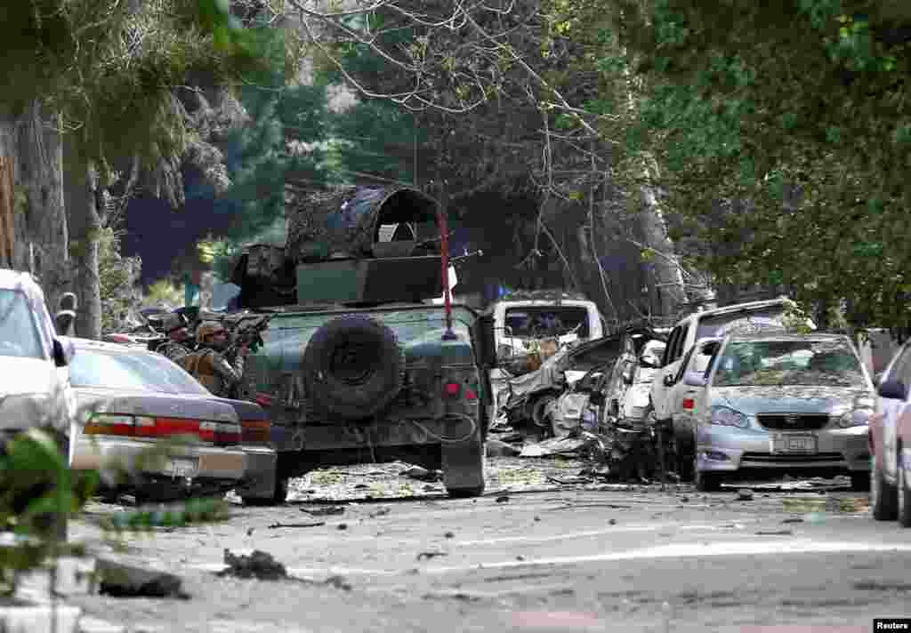 Afghan security forces take position during a gunmen attack in Kabul, Afghanistan.