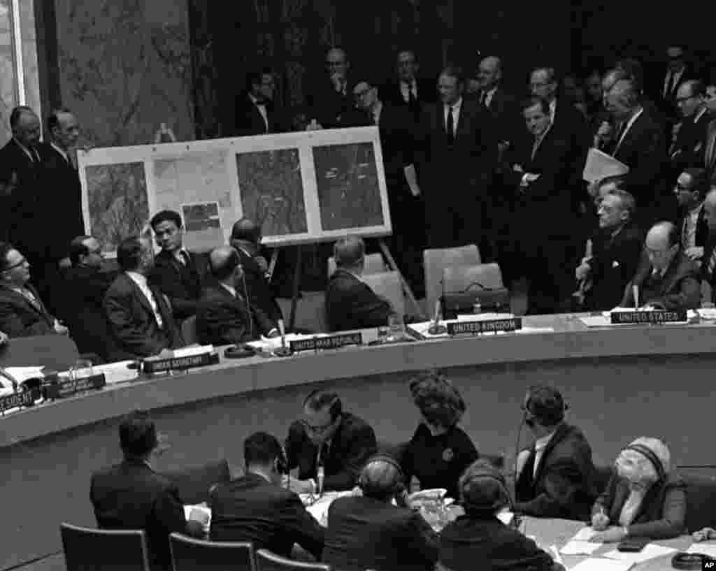 In this October 25, 1962 file photo, U.S. Ambassador Adlai Stevenson, far right, describes aerial photographs of launching sites for intermediate range missiles in Cuba during an emergency session of the United Nations Security Council at U.N. Headquarter