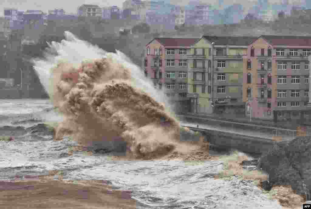 Waves hit a sea wall in front of buildings in Taizhou, China's eastern Zhejiang province. China issued a red alert for incoming Super Typhoon Lekima, expected to batter eastern Zhejiang province early on Aug. 10.