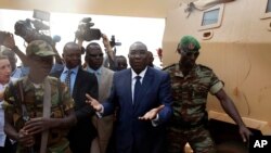 Michel Djotodia, Central African Republic's president, walks back to the Chadian armored vehicle he arrived in following his meeting with US Ambassador to the United Nations Samantha Power at the airport in Bangui, Central African Republic, Thursday Dec. 
