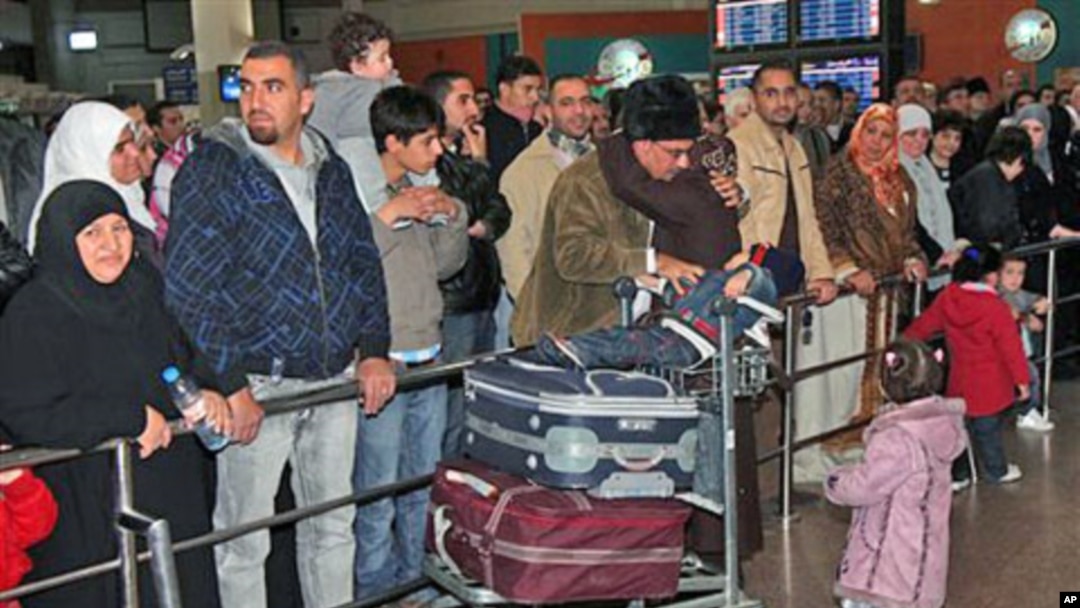 A Jordanian woman evacuated from Tripoli is received by her family as she arrives in Queen Alia Airport near Amman, Jordan, February 21, 2011
