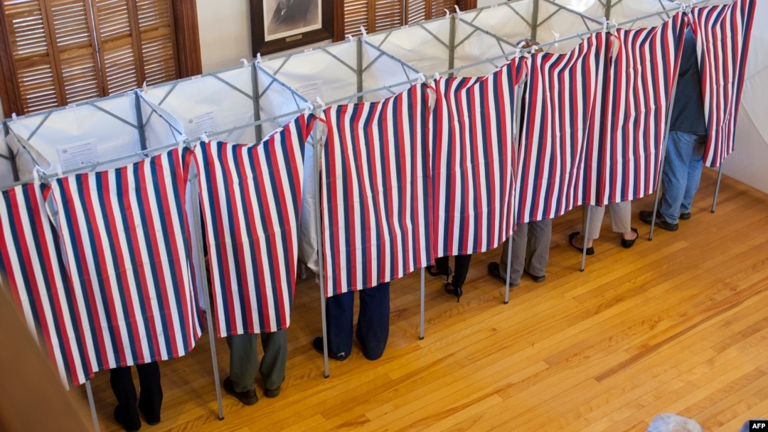 FILE - Voters cast their ballots at the Sutton town hall in the US presidential election, Nov. 8, 2016 in Sutton, New Hampshire. 