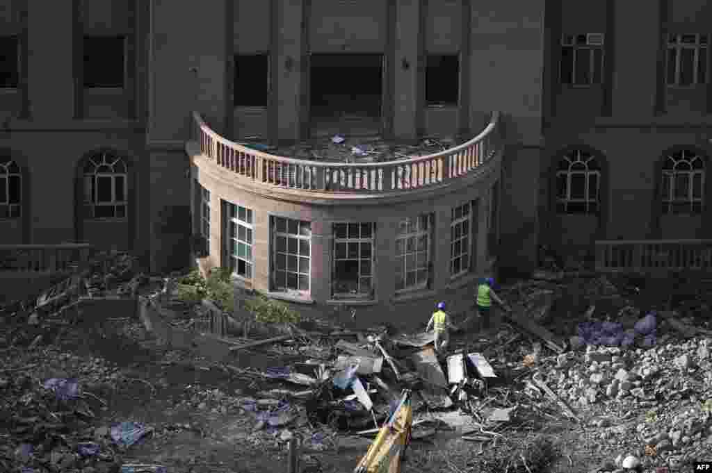 Workers walk at the demolition site of the former U.S. embassy in Beijing, China, 20 years after it was attacked by Chinese protesters on May 8, 1999.