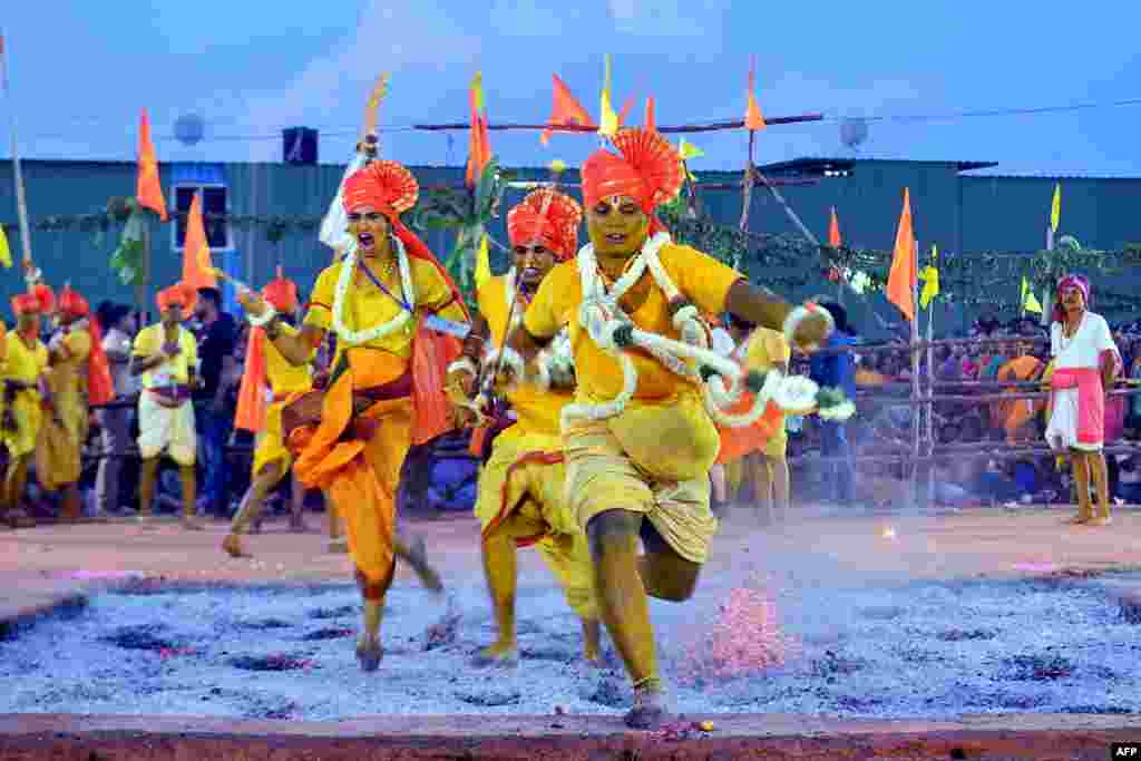 Hindu devotees run through red hot embers as part of annual fire walking ritual during 'Draupadi Amman' festival in Bangalore, India.