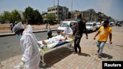 A patient is wheeled outside a COVID-19 hospital, amidst the spread of the coronavirus disease, in Ahmedabad, India, April 19, 2021. 