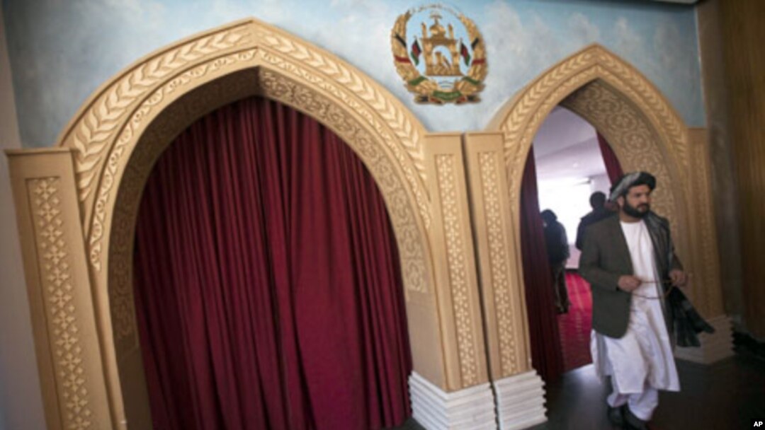A member of Afghanistan's parliament leaves a meeting hall at the Inter-continental hotel in Kabul, 22 Jan 2011