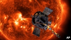 This image made available by NASA shows an artist's rendering of the Parker Solar Probe approaching the Sun. It's designed to take solar punishment like never before, thanks to its revolutionary heat shield that’s capable of withstanding 2,500 degrees Fahrenheit (1,370 degrees Celsius).