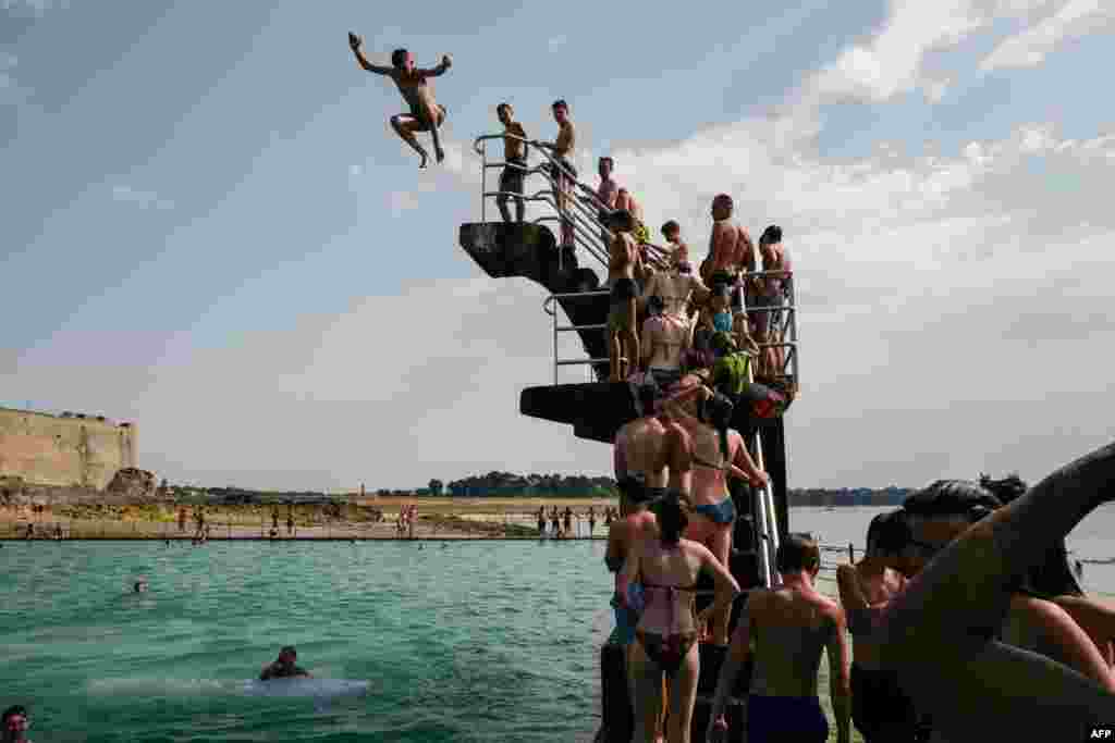 People queue to dive into the landmark sea pool of Saint-Malo, Brittany, France, as a new heatwave blasted into northern Europe that could set records in several countries.