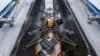 In this undated image released by NASA, Intuitive Machines’ newest lunar lander is seen attached to a SpaceX Falcon rocket.