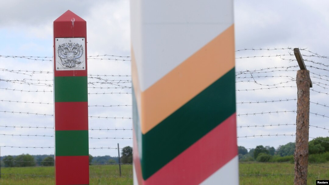 Lithuanian (R) and Russian border signs are seen near the Sudargas border crossing point with Russia in Ramoniskiai, Lithuania, June 5, 2017.