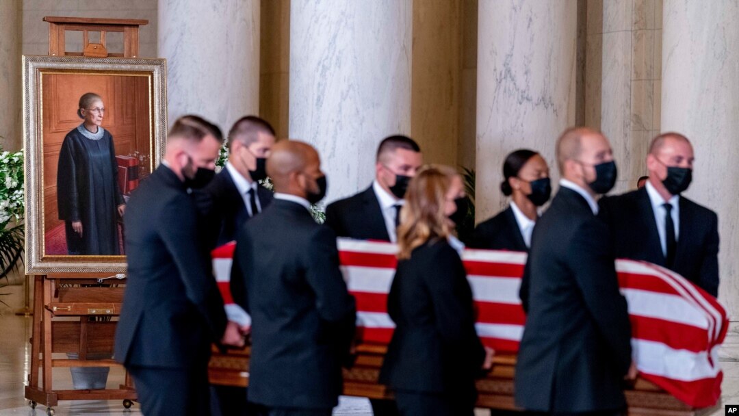The flag-draped casket of Justice Ruth Bader Ginsburg, carried by Supreme Court police officers, arrives in the Great Hall at the Supreme Court in Washington, Sept. 23, 2020. 