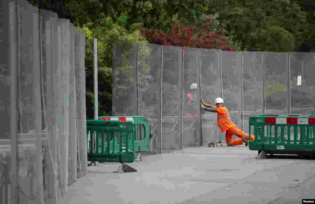 Workmen construct fences around the U.S. ambassador's residence in Regent's Park in London, Britain, ahead of a visit by US President Donald Trump.