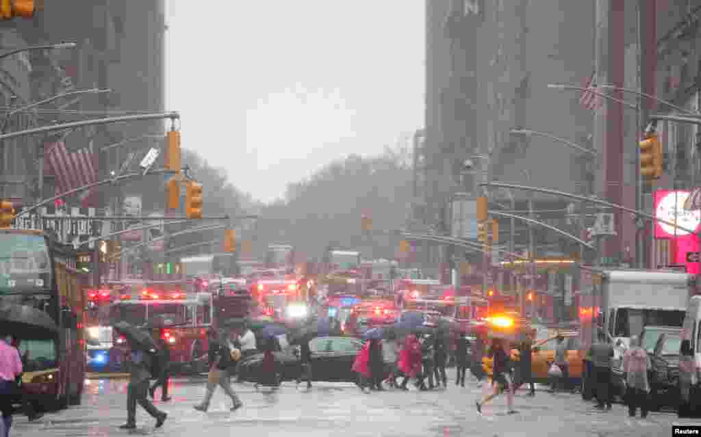 Emergency vehicles fill the street at the scene after a helicopter crashed atop a building in Times Square and caused a fire in the Manhattan borough of New York.