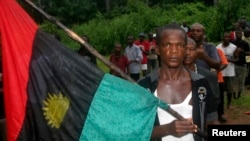FILE - A man carries the Biafran flag during a parade in Ekwe village, near Enugu, southeastern Nigeria.