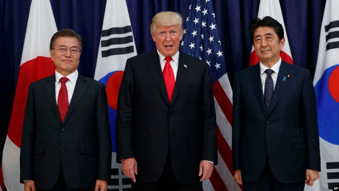 FILE - President Donald Trump meets with Japanese Prime Minister Shinzo Abe, right, and South Korean President Moon Jae-in before the Northeast Asia Security dinner at the US Consulate General in Hamburg, Germany, July 6, 2017.