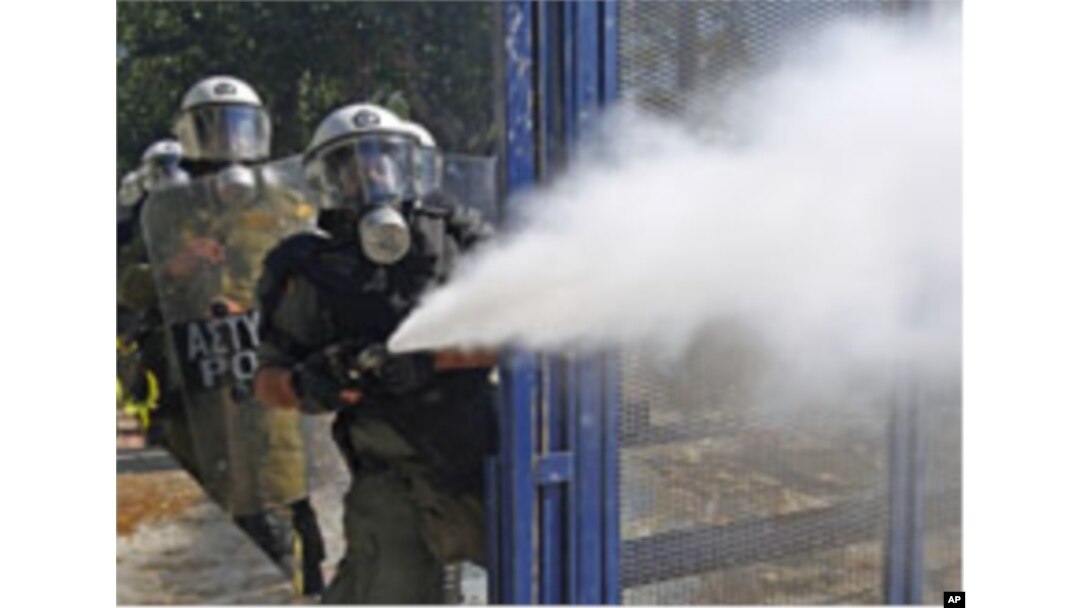 Riot police spray tear gas at demonstrators during clashes in Athens' Syntagma [Constitution] square, October 19, 2011.