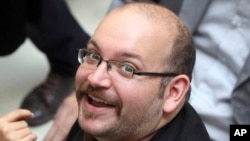 FILE - Jason Rezaian, an Iranian-American correspondent for the Washington Post smiles as he attends a presidential campaign of President Hassan Rouhani in Tehran, Iran.