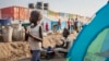 FILE - A young displaced girl washes clothes alongside a row of tents in the United Nations camp in Juba, South Sudan. Since December, over a million people in the country have been displaced by fighting. (AP) 
