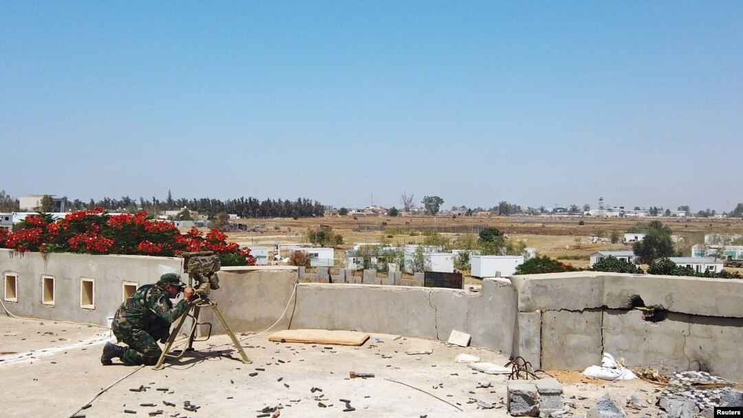 FILE - A member of the Libyan internationally recognized government forces is seen during a fight with Eastern forces, in southern Tripoli, Libya, June 22, 2019.