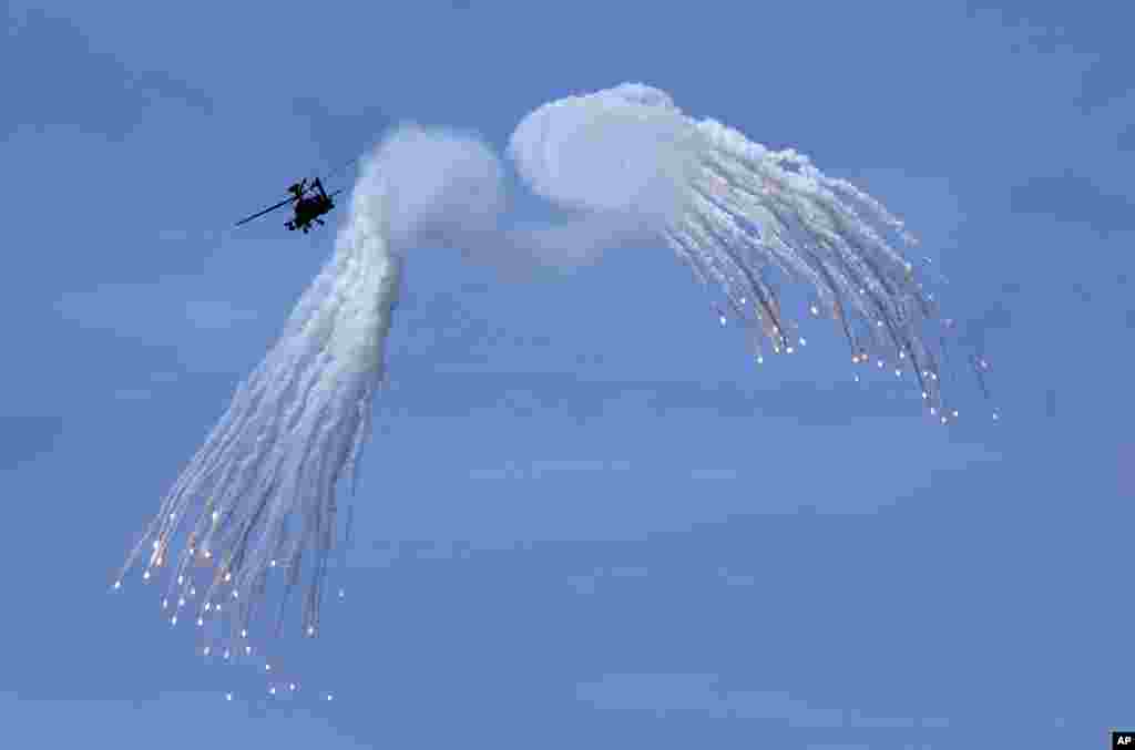 Taiwan's AH-64E Apache attack helicopter launches flares during the annual Han Kuang exercises in Pingtung County, Southern Taiwan.