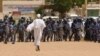 Anti-government protestor faces riot police last week in Khartoum. (A. Ahmed/VOA)