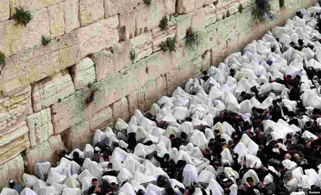 Worshipers pray during a priestly blessing on the Jewish holiday of Passover at the Western Wall, Judaism's holiest prayer site, in Jerusalem's Old City.