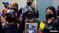 Myanmar citizens hold a portrait of former Myanmar state counselor Aung San Suu Kyi as they protest against the execution of pro-democracy activists at Myanmar's embassy in Bangkok, Thailand, on July 26, 2022. (Soe Zeya Tun/Reuters)