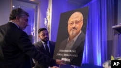 Mongi Dhaouadi (L) and Ahmed Bedier set up an image of slain Saudi journalist Jamal Khashoggi before an event to remember Khashoggi, a columnist for The Washington Post who was killed inside the Saudi Consulate in Istanbul on Oct. 2, in Washington, Nov. 2, 2018.