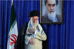 Iranian Supreme Leader Ayatollah Ali Khamenei gestures to a crowd at a June 4, 2019 ceremony in Tehran.