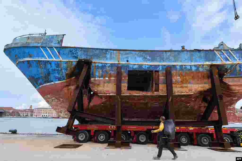 The fishing vessel "Barca Nostra" (Our Ship) that sank on April 18, 2015, trapping hundreds of migrants in its hull, is being installed in Venice's former shipyards, Italy, as part of the centerpiece of a new art project by Swiss-Icelandic artist Christoph Buechel, prior to the the 58th International Art Exhibition of the Venice Biennale, May 7, 2019.
