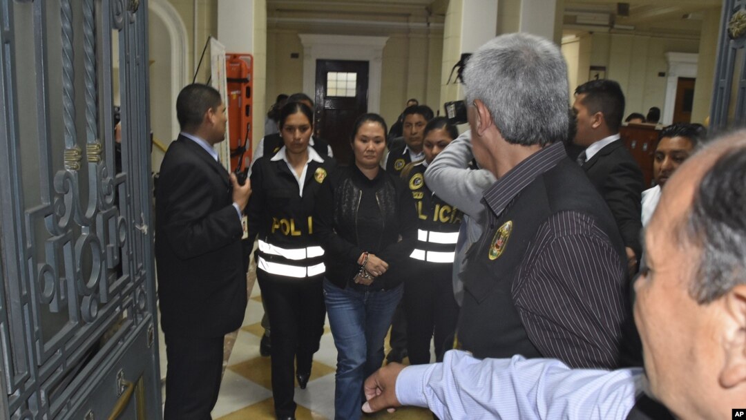 En esta foto proporcionada por la oficina de comunicaciones de la Corte Suprema de Perú, Keiko Fujimori es llevada a la cárcel con esposas luego de que el juez Richard Concepción dictaminó que debía ser detenida.