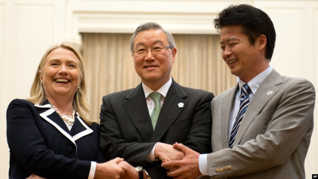 U.S. Secretary of State Hillary Rodham Clinton, left, South Korean Foreign Minister Kim Sung-hwan, center, and Japanese Foreign Minister Koichiro Gemba shake hands before their trilateral meeting during the ASEAN Regional forum in Phnom Penh, Cambodia, Ju