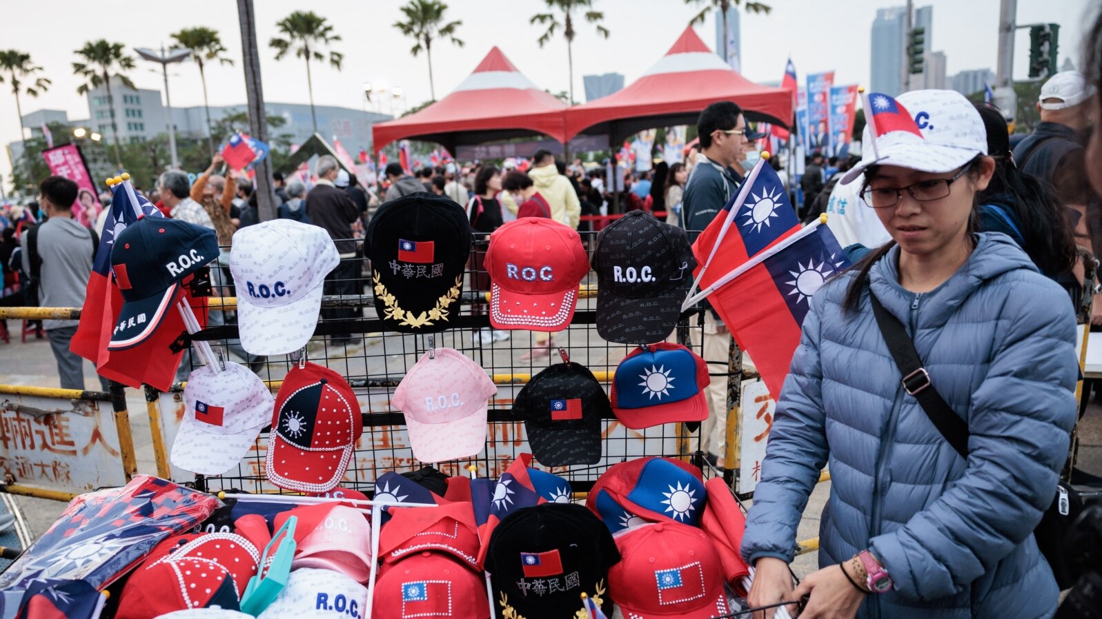 A street vender sells Taiwan flags and caps at a campaign rally of the main opposition Kuomintang (KMT) in Kaohsiung on Jan. 7, 2024, a week before the presidential election.