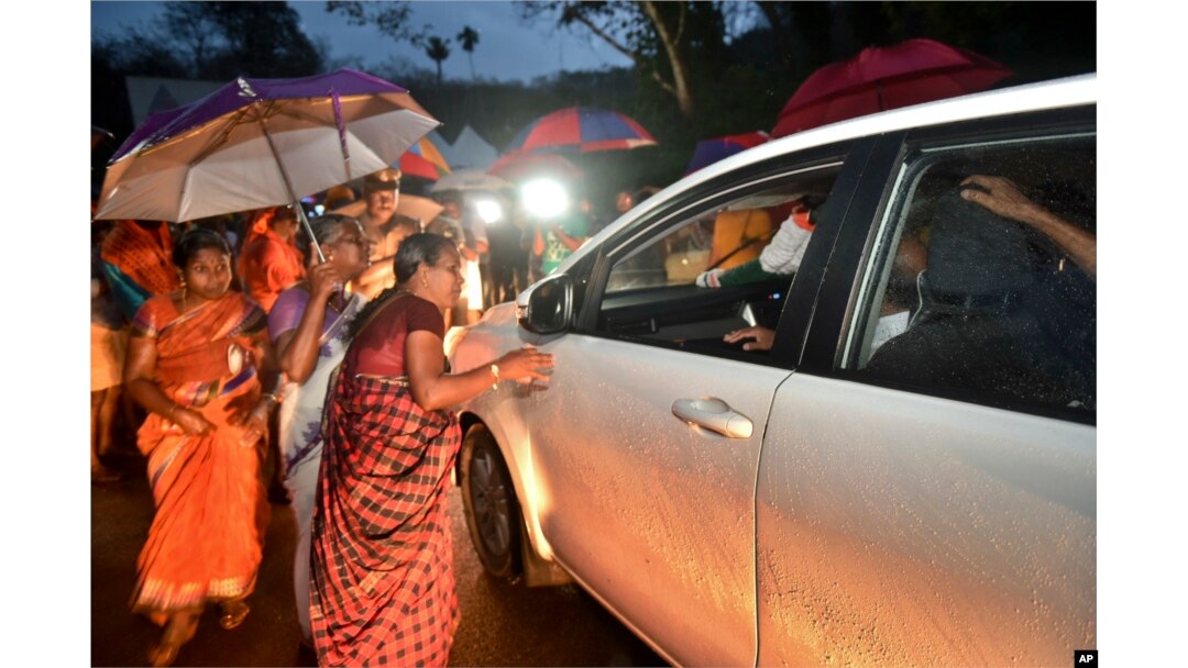 Hindu women favoring barring women of menstruating age from entering the Sabarimala temple scan vehicles at Nilackal, a base camp on way to the mountain shrine in Kerala, India, Oct. 16, 2018.