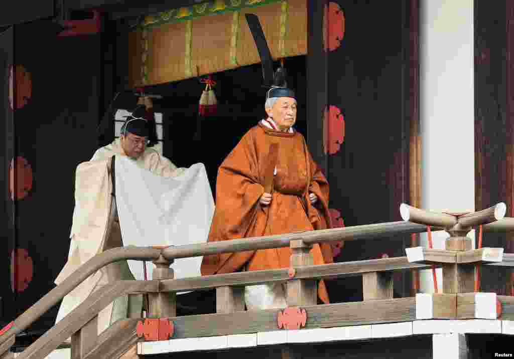 Japan's Emperor Akihito walks for a ritual called Taiirei-Tojitsu-Kashikodokoro-Omae-no-gi, a ceremony for the Emperor to report the conduct of the abdication ceremony, at the Imperial Palace in Tokyo, in this photo released by Kyodo.