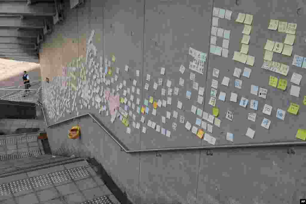 Stickers with messages supporting protesters are left on a wall near the Legislative Council in Hong Kong. Calm returned to the streets following protests by students and human rights activists opposed to a bill that would allow suspects to be tried in mainland Chinese courts.