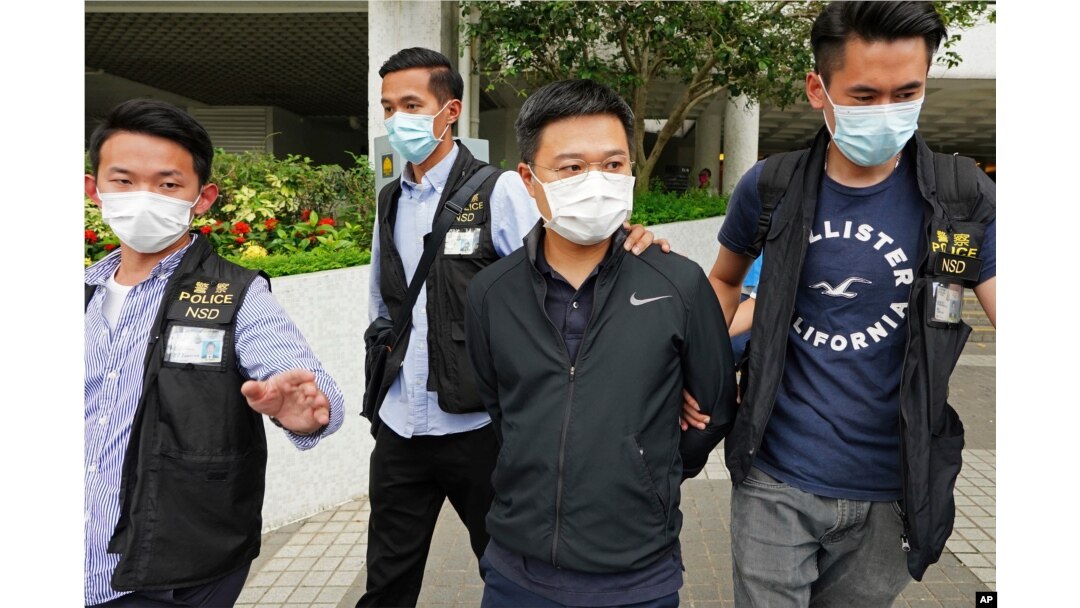 FILE - Ryan Law, second from right, being arrested by police officers in Hong Kong, June 17, 2021.