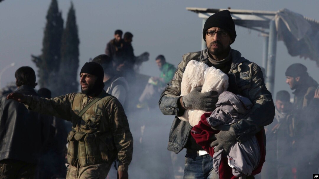 Syrians evacuated from the embattled Syrian city of Aleppo during the cease-fire arrive at a refugee camp in Rashidin, near Idlib, Syria, early Monday, Dec. 19, 2016.