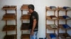 A worker at the Humidors Habana Art Creation Workshop shows cigar humidifiers in Havana, Cuba, Feb. 19, 2025.