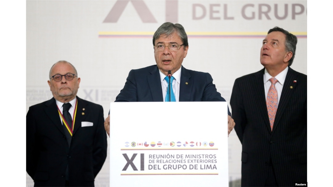 Colombia's Foreign Affairs Minister Carlos Holmes Trujillo reads the final statement after a meeting of the Lima Group in Bogota, Colombia, Feb. 25, 2019.