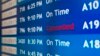 A departure board at the Philadelphia International Airport shows that US Airways Flight 796 to Tel Aviv has been canceled, July 22, 2014. 