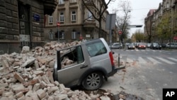 A car is crushed by falling debris after an earthquake in Zagreb, Croatia, March 22, 2020. 