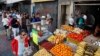 Archivo - Residentes de Caracas esperan en fila para comprar alimentos durante una apagón el 10 de marzo de 2019.