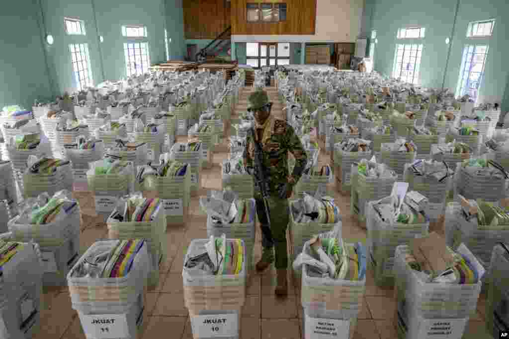 A policeman guards ballot boxes and election materials to be distributed to polling stations, at a counting center in Nairobi, Kenya. Kenya is voting on Aug. 9, 2022, in an election that will bring East Africa's economic hub a new president after a decade. 