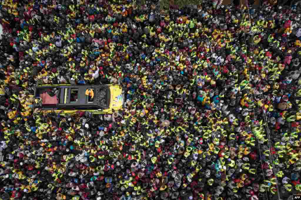 This aerial view shows Kenya's Deputy President and presidential candidate William Ruto of Kenya Kwanza (One Kenya) political party coalition speaking to supporters from a car during his rally in Thika.